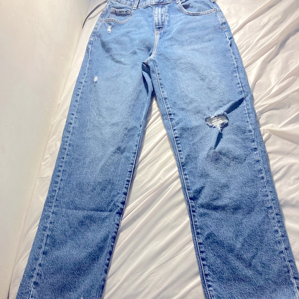 Dark blue ripped jeans with edges cut